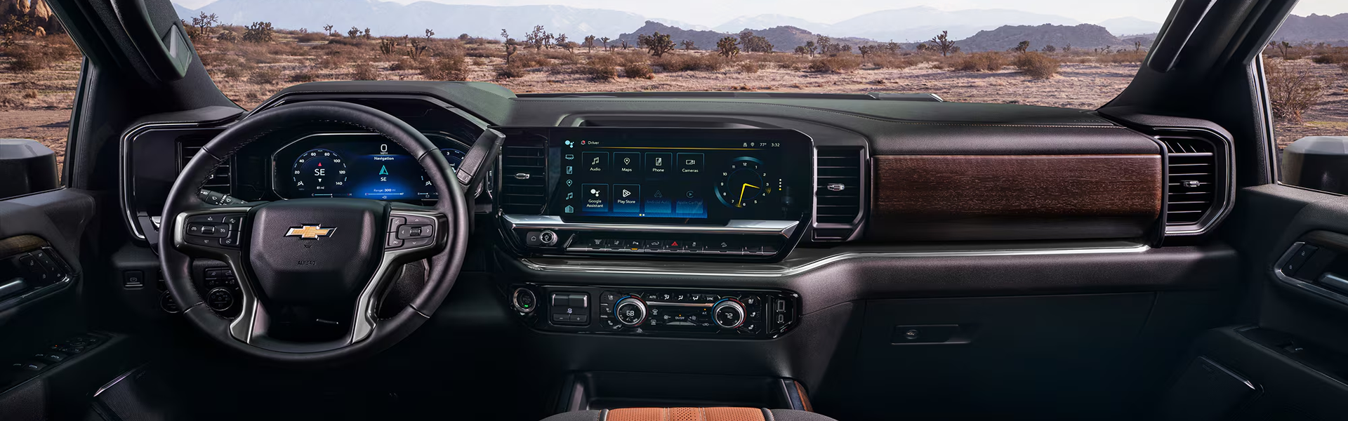 Chevrolet Silverado HD dashboard with wood-trim accents overlooking a desert landscape