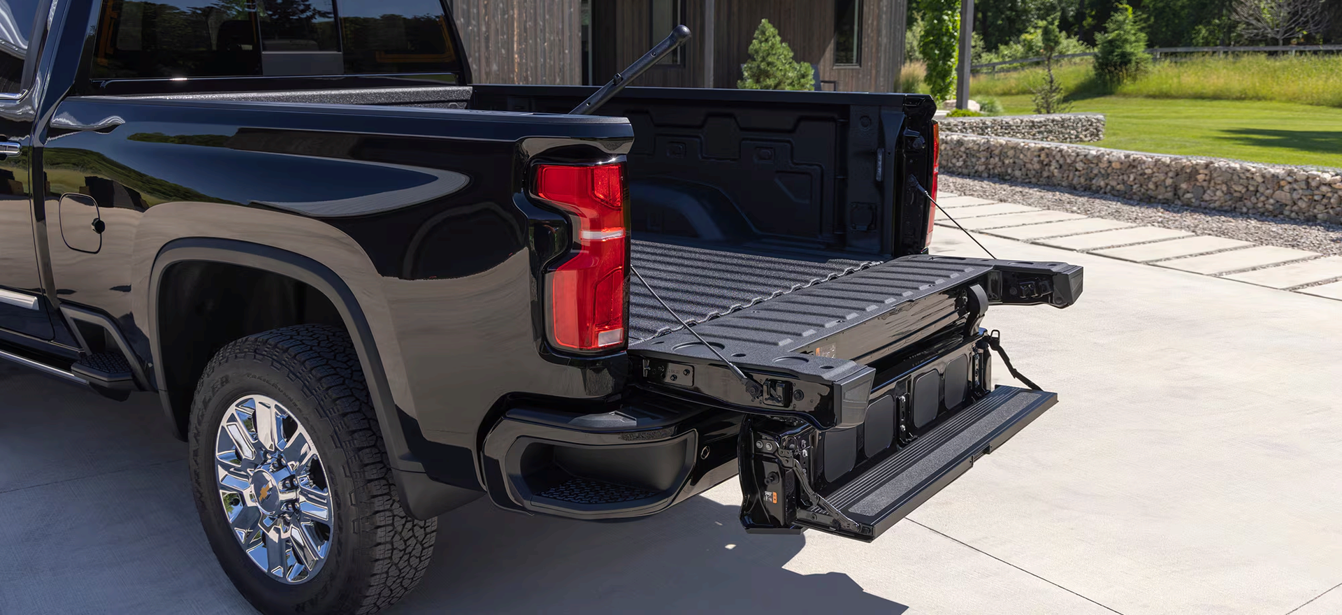 Black Chevrolet Silverado HD with the Multi-Flex Tailgate's inner gate folded down into a step