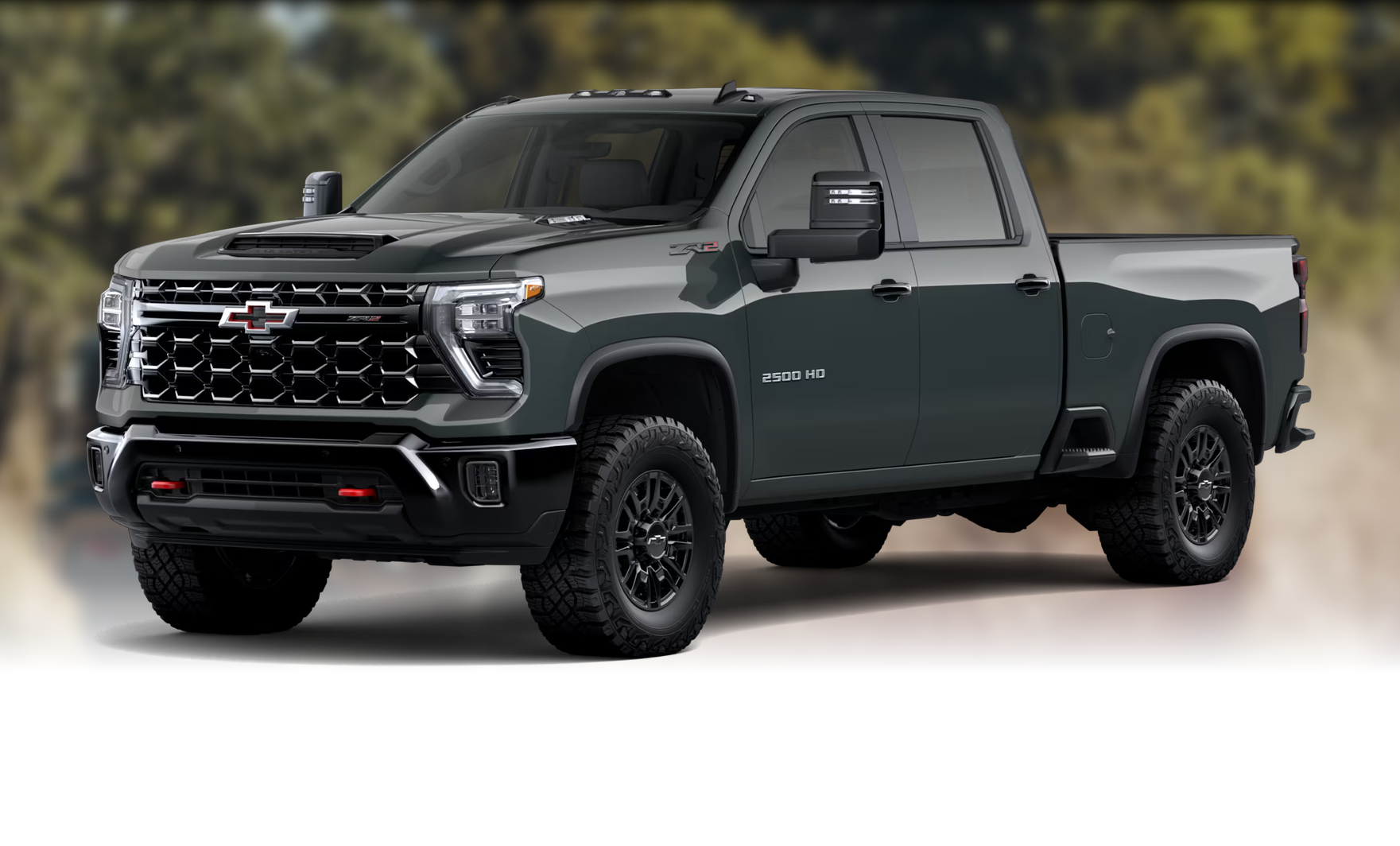 Dark green Chevrolet Silverado 2500 HD ZR2 in front of a soft-focus forest