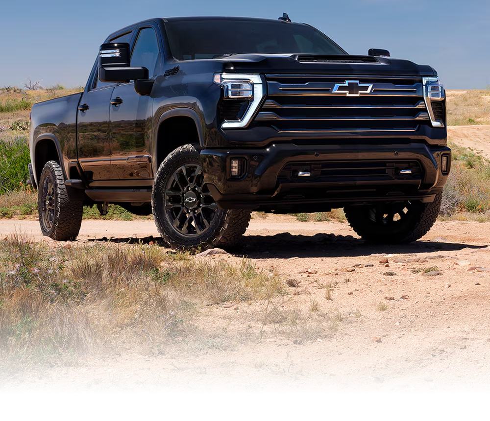 Black Chevrolet Silverado HD High Country Midnight Edition parked on a desert trail