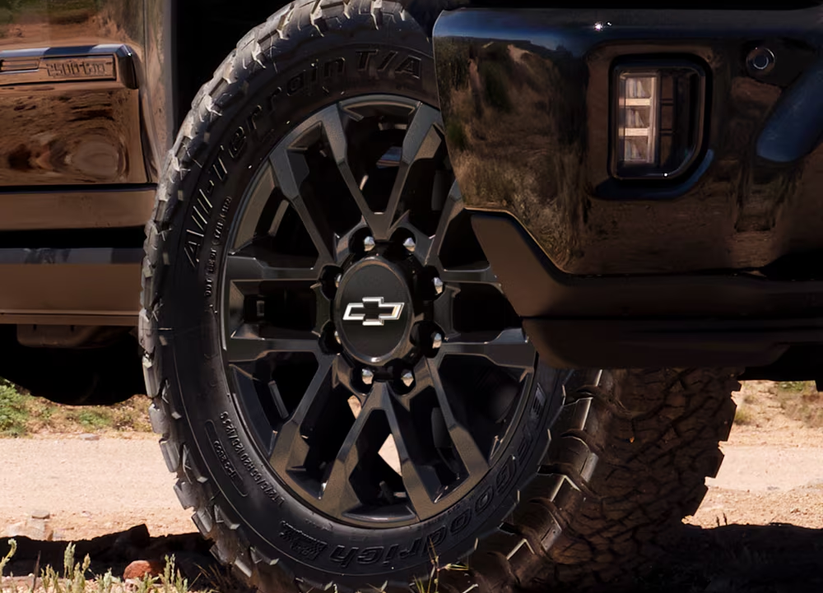 Close-up of a black-painted wheel and off-road tire on a Chevrolet Silverado HD