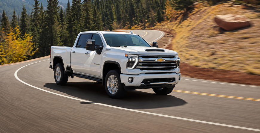 White Chevrolet Silverado HD Z71 Chrome Sport Edition rounding a curve on a mountain road
