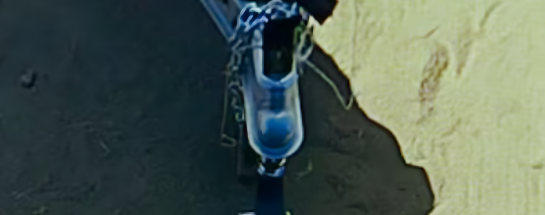 Overhead hitch camera view of a trailer hitch ball lined up for coupling