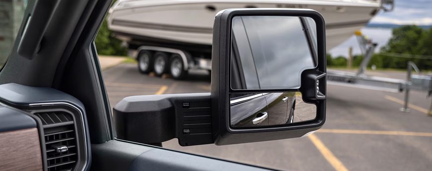 Silverado HD trailering side mirror with a boat trailer visible beside the truck