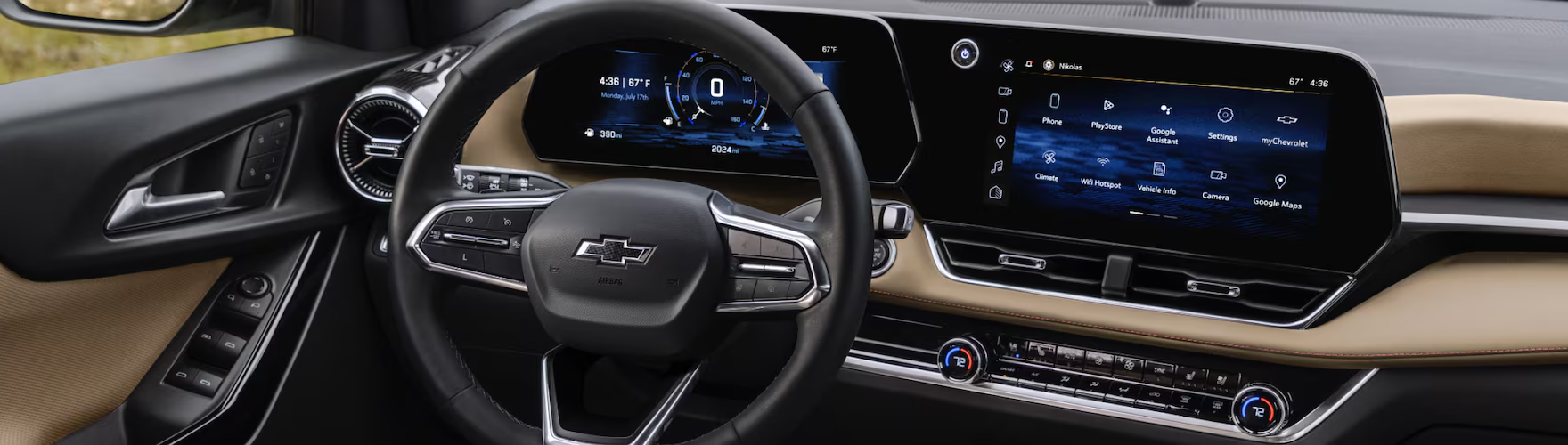 Chevrolet Equinox steering wheel in front of the digital driver display and center touchscreen