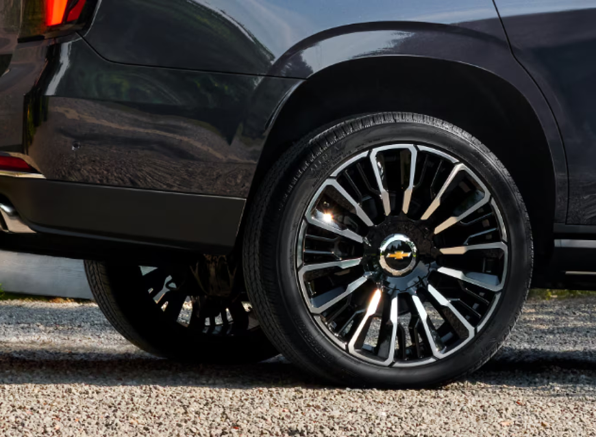 Close-up of a black Tahoe High Country with a bright machined 24-inch wheel