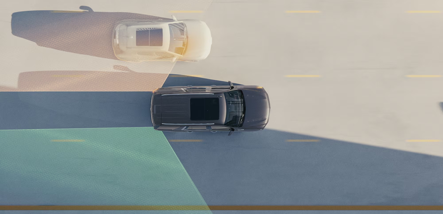 Overhead view of a Chevrolet Tahoe with highlighted blind zones and a vehicle alongside