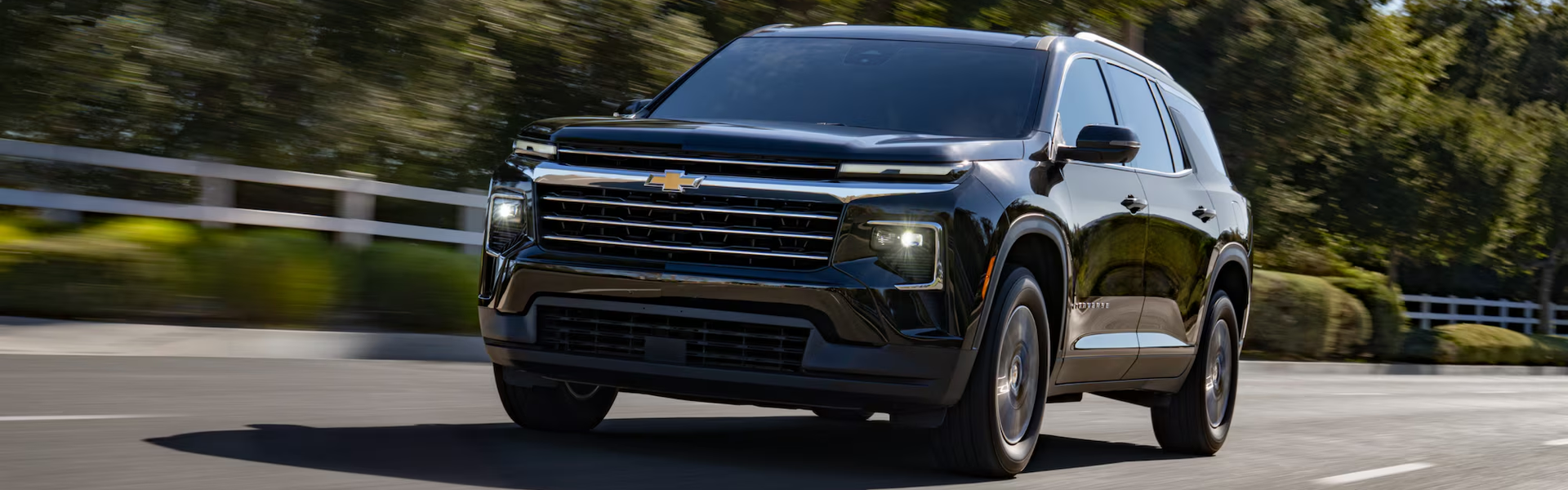 Black 2027 Chevrolet Traverse driving along a country road