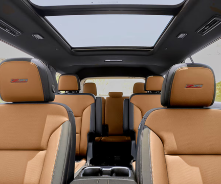 Tan seats in all three rows of a Chevrolet Traverse under the panoramic sunroof