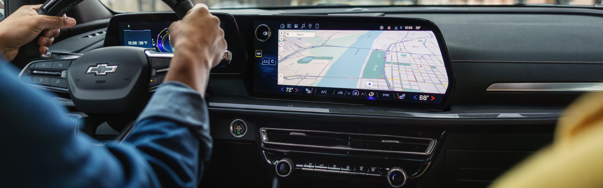 Driver tapping the Chevrolet Traverse center touchscreen