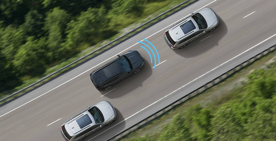 Overhead view of a 2027 Jeep Cherokee sensing a vehicle in the next lane on a highway
