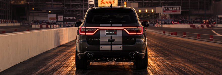 Rear of a dark Dodge Durango showing its LED Racetrack Taillight on a drag strip