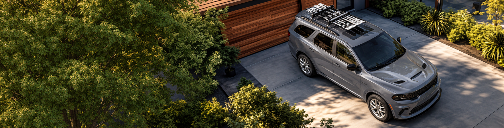Gray Dodge Durango with a loaded roof rack parked in a driveway
