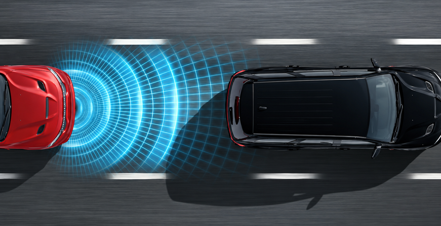 Overhead view of a black Dodge Durango with braking sensor waves toward a red vehicle