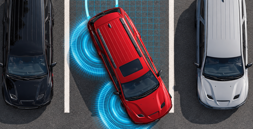 Overhead view of a red Dodge Durango reversing out of a parking space with sensor waves