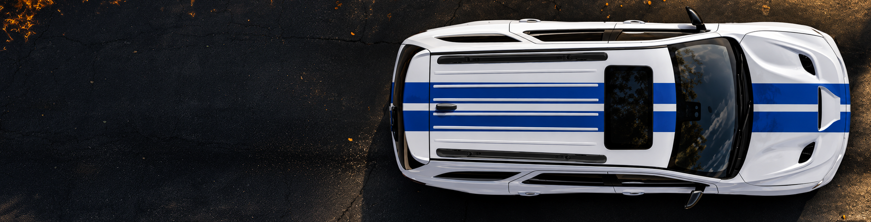 Overhead view of a white Dodge Durango with blue racing stripes and an open sunroof