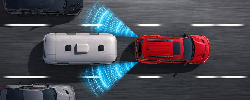 Overhead view of a red Dodge Durango towing a camper trailer with blind spot sensor waves