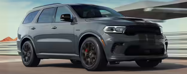 Gray Dodge Durango with black wheels on a racetrack