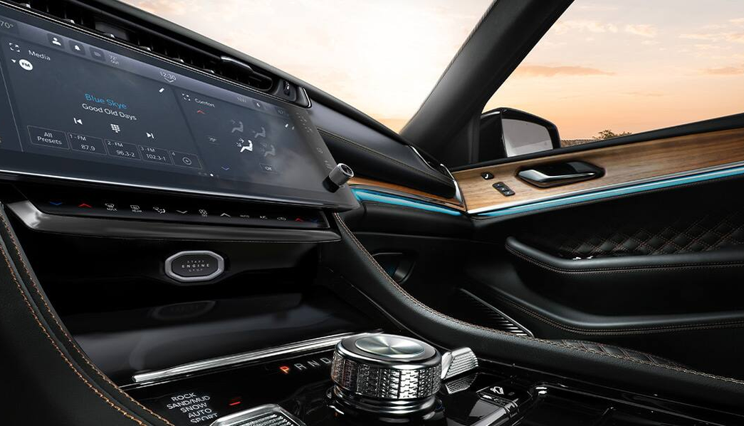 Grand Cherokee passenger-side dash with wood trim and ambient lighting