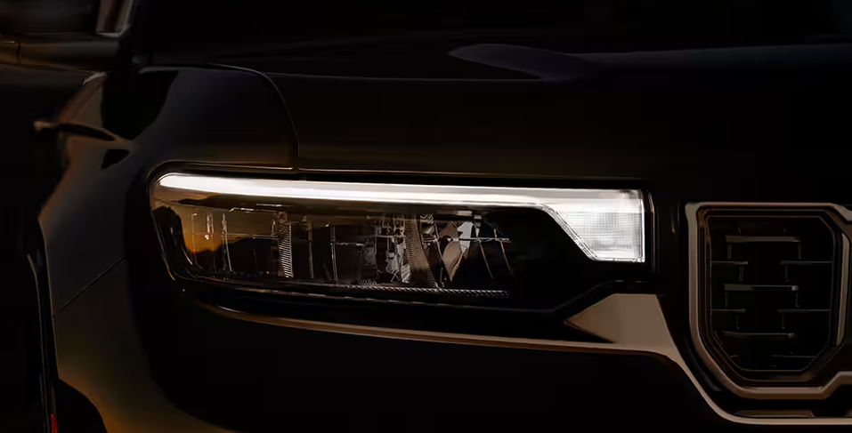 Close-up of a Grand Cherokee LED headlamp glowing at night
