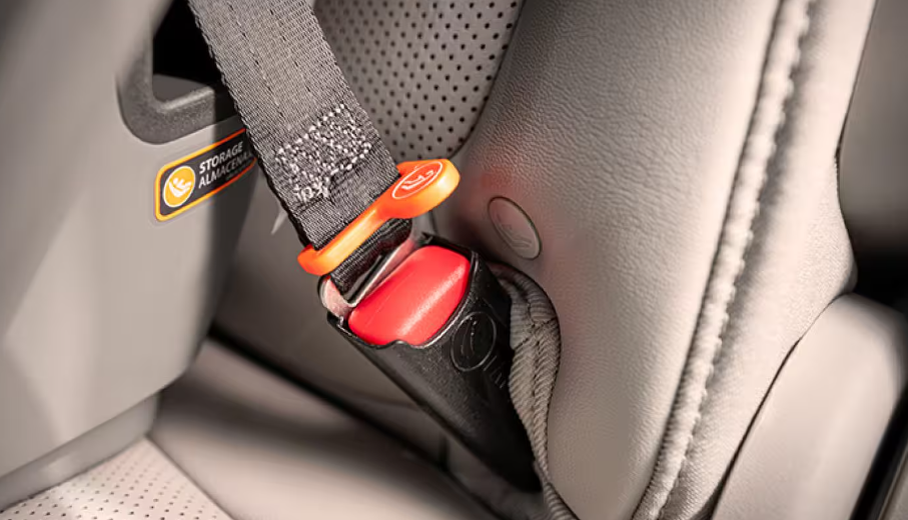 Seat belt buckle and LATCH anchor on a gray leather rear seat
