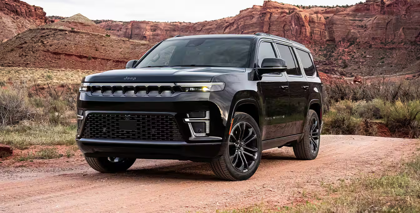 Black 2027 Jeep Grand Wagoneer parked in red rock desert