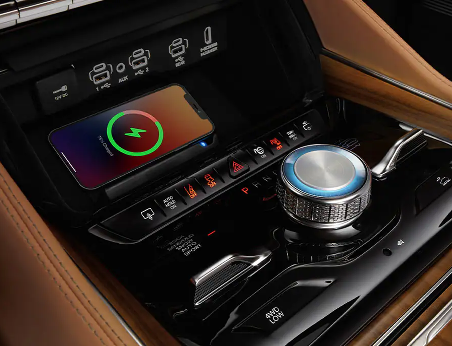 Wireless charging pad and rotary shifter in the center console