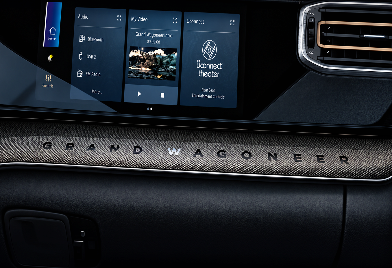 Dashboard screens above a dark metal trim panel engraved Grand Wagoneer