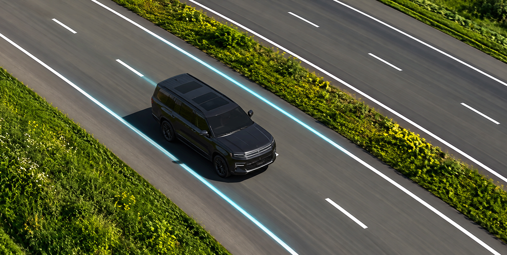 Overhead view of a Grand Wagoneer centered in its lane on a highway