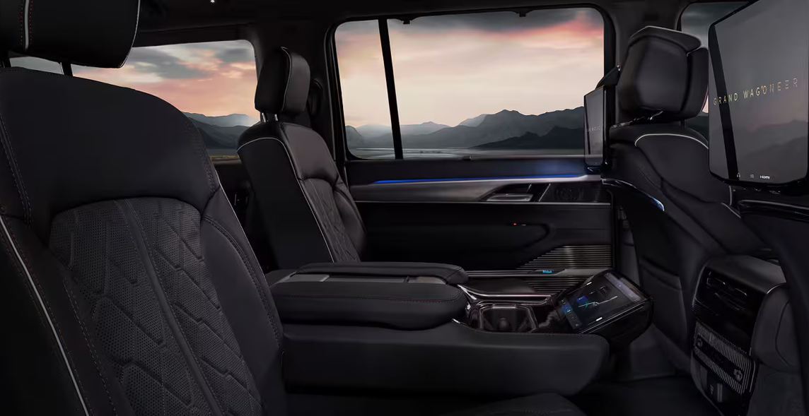 Spacious second-row captain&rsquo;s chairs with a sunset view through the windows