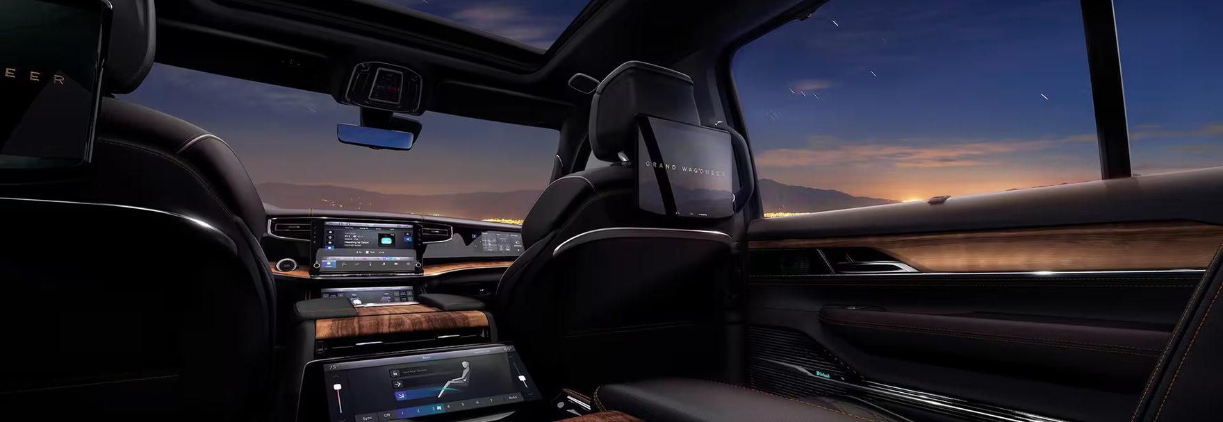 Second-row view of the cabin with a panoramic roof and rear seat screens
